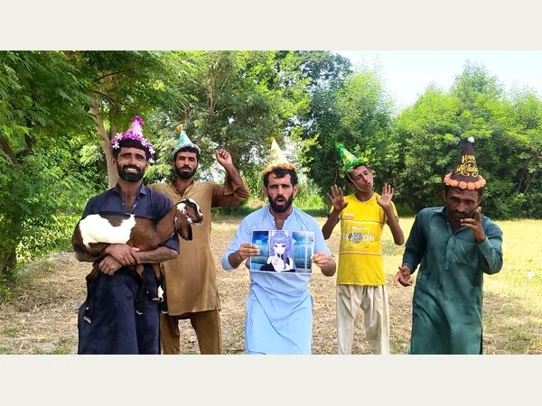 Village team singing together during a video shoot