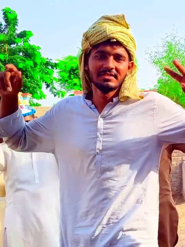 Awais, Animal Handler at VillageWishes, with a village goat
